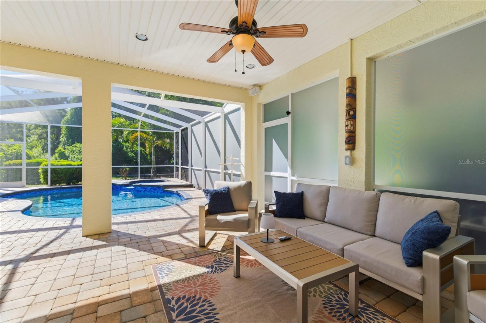 Relax under the covered lanai overlooking your private pool and spa, where indoor comfort meets outdoor living. This inviting space is perfect for morning coffee, afternoon lounging, or evening gatherings, complete with ceiling fan and shaded seating. Designed for year-round enjoyment, the seamless connection to the pool area creates the ultimate Florida outdoor retreat.