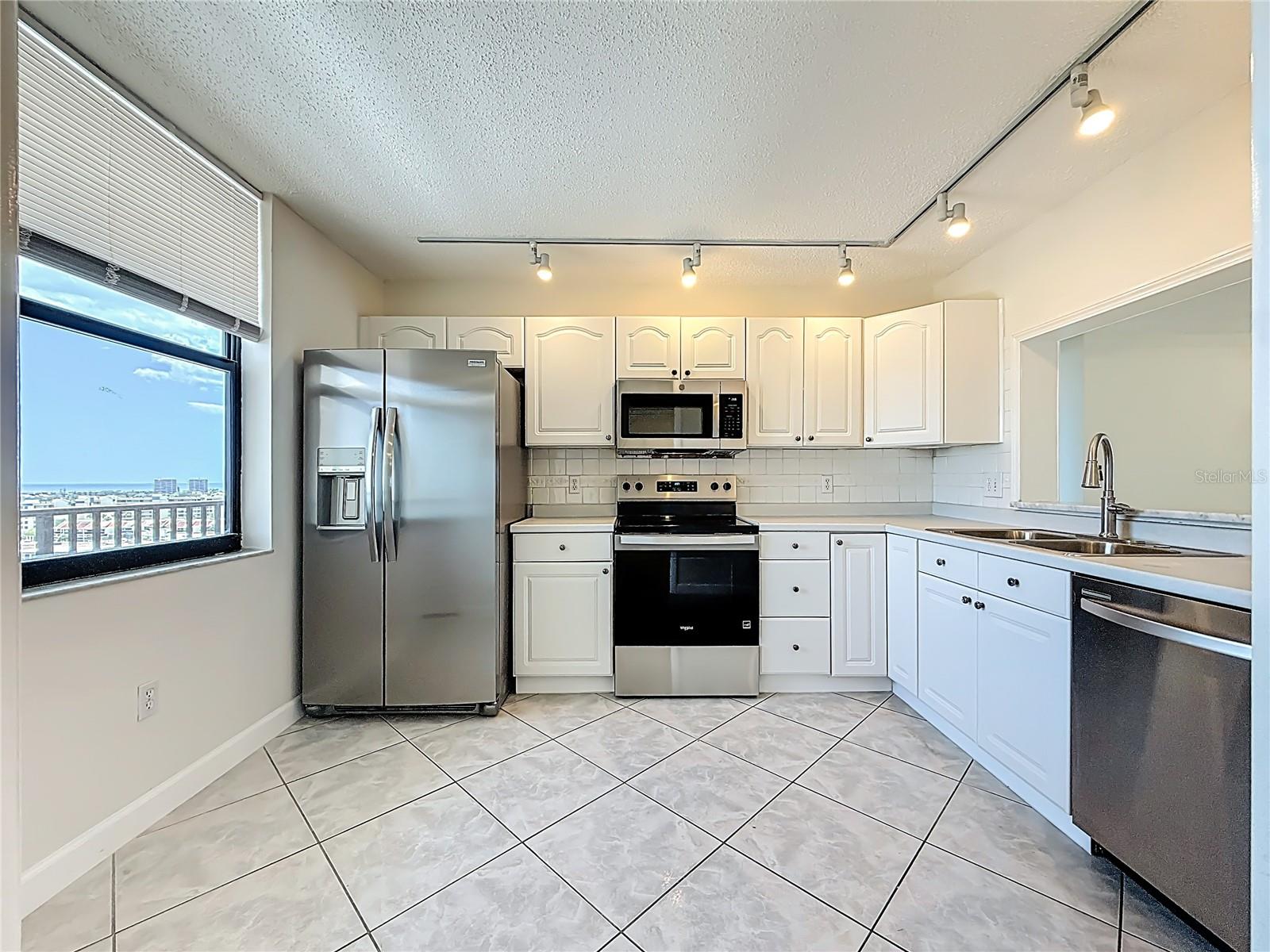This kitchen has newer stainless steel appliances.