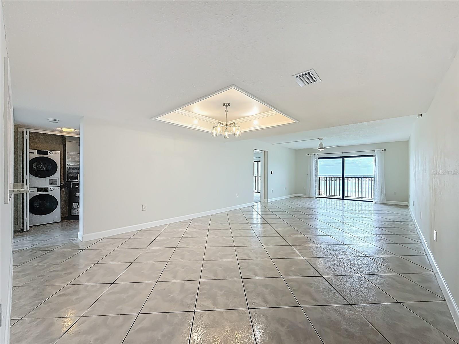 Another view of the living and dining area showing entrances to guest bedroom & primary bedroom