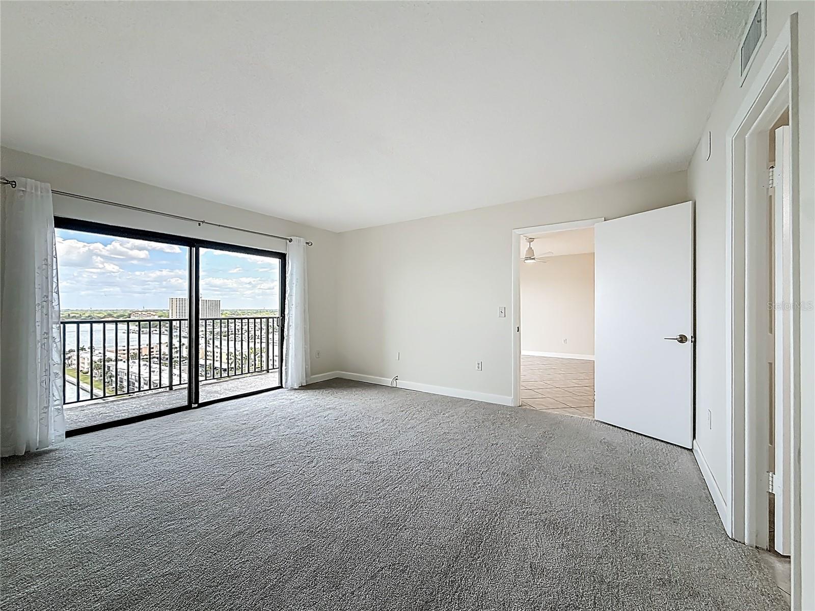 Another view of the primary bedroom showing what a nice view you have