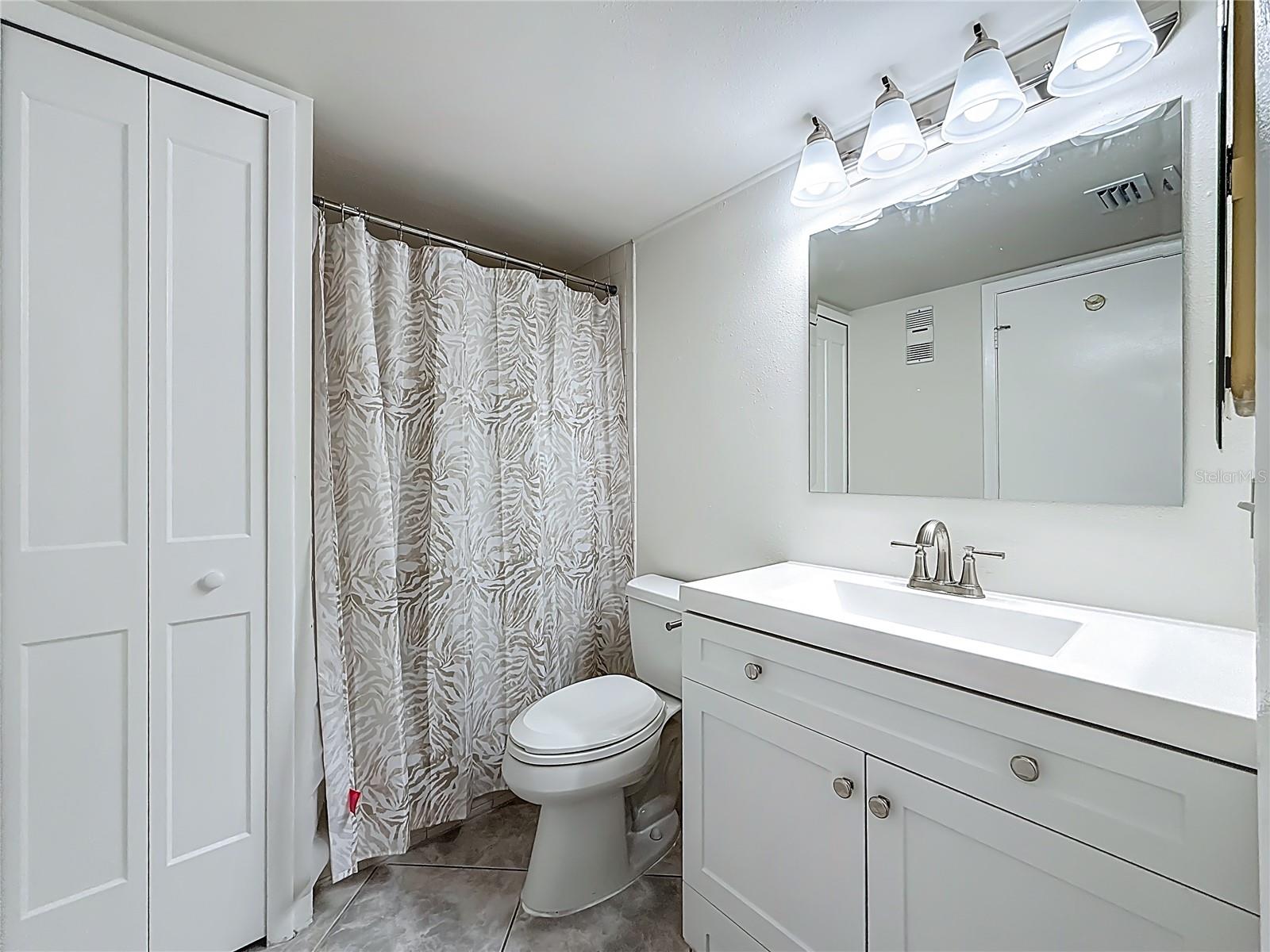 Ensuite bathroom with shower & nice vanity plus linen closest