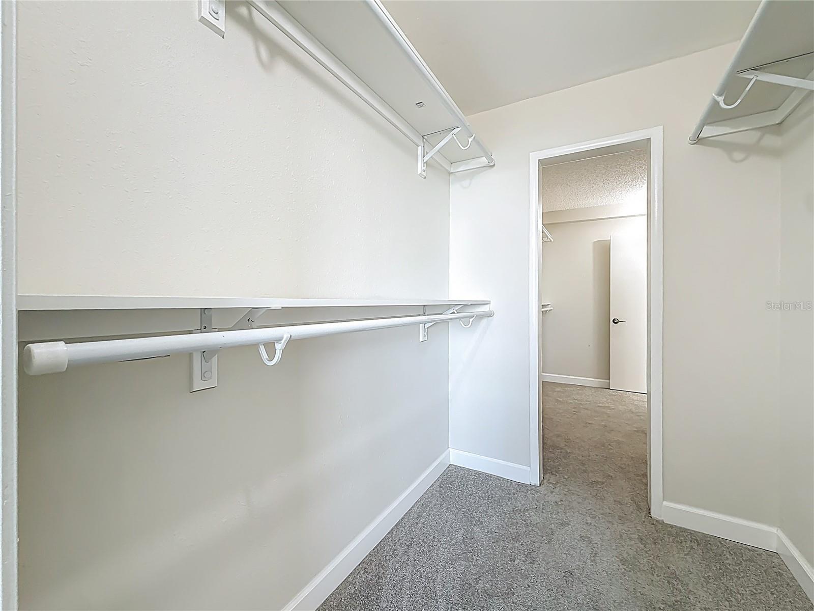 There is a walk in closest in the primary bedroom and the 2nd guest bedroom.  You can walk thru from both bedrooms into the closests.  That wall can be closed up if you wanted separate closests.