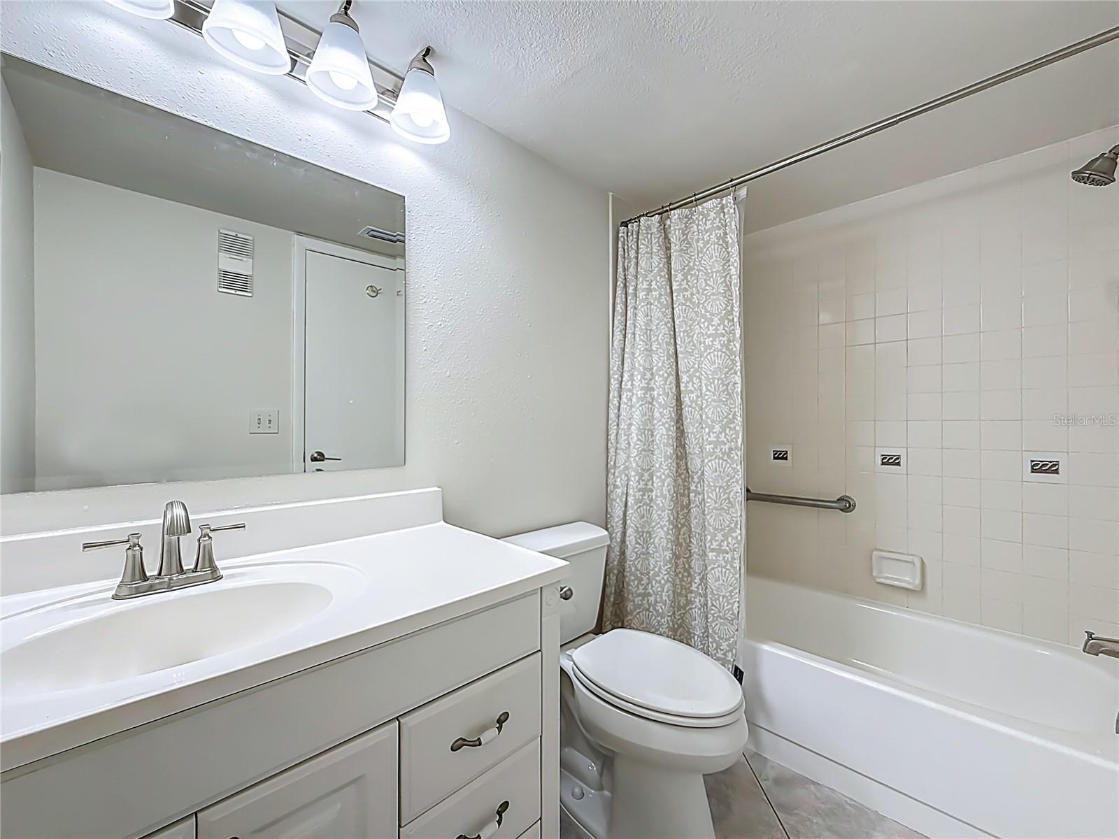 This bathroom has a tub with a shower
