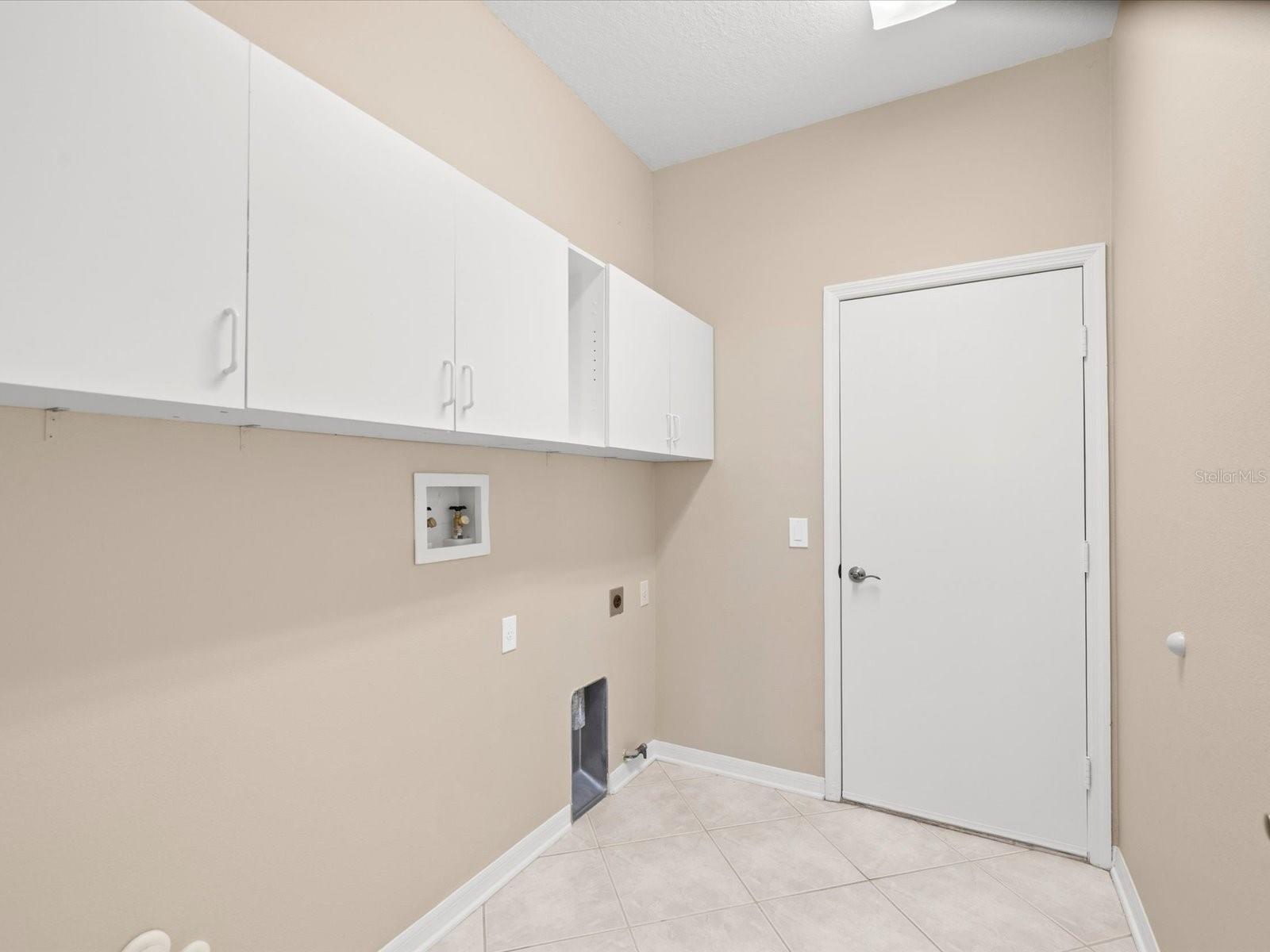 Laundry room with storage, connects to garage and hallway.