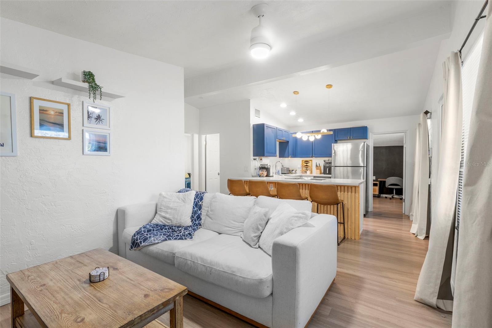 Open-concept living room flows seamlessly into the kitchen for easy entertaining.