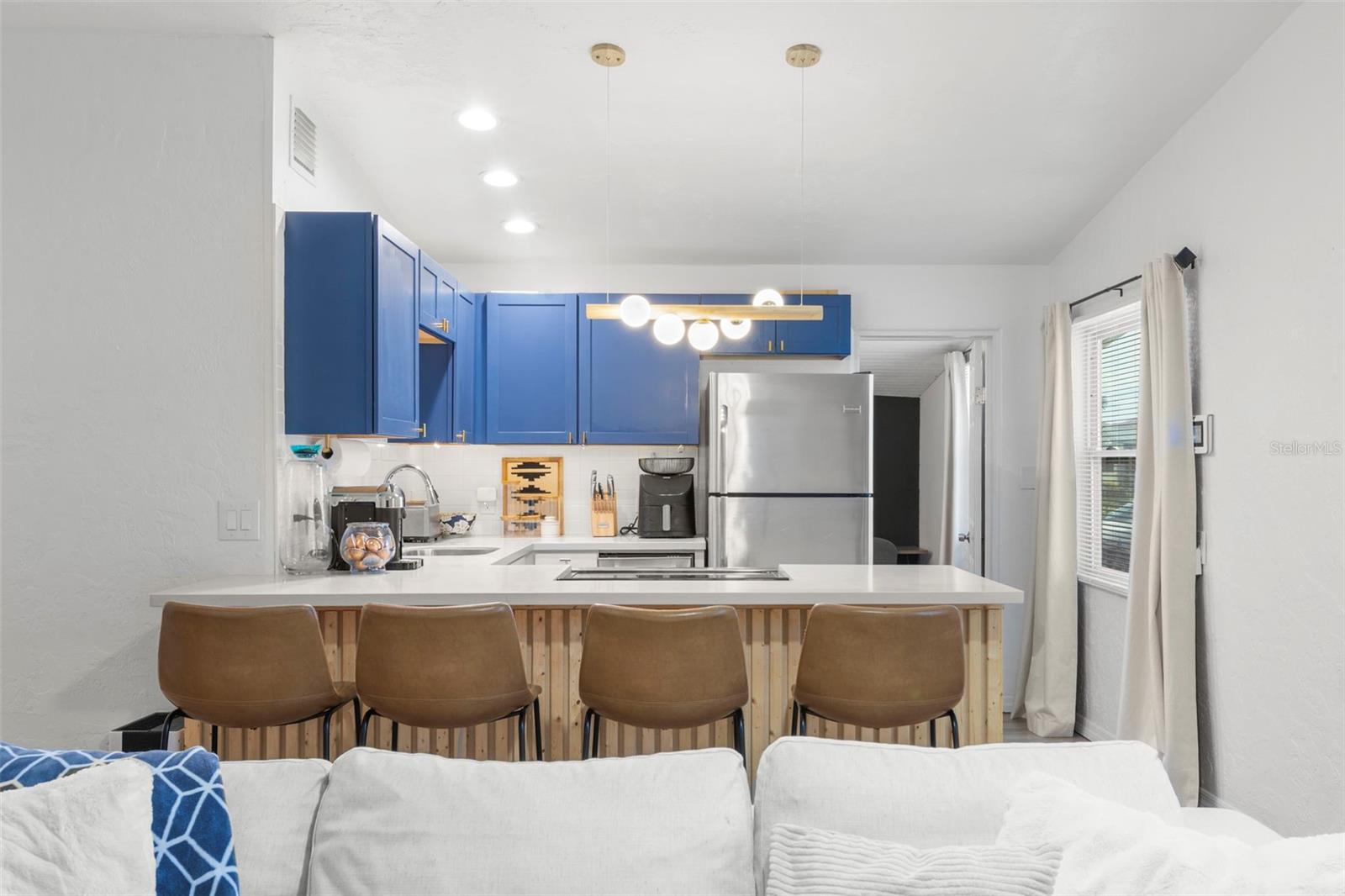 Designer-inspired kitchen with oversized breakfast bar and seating for four.