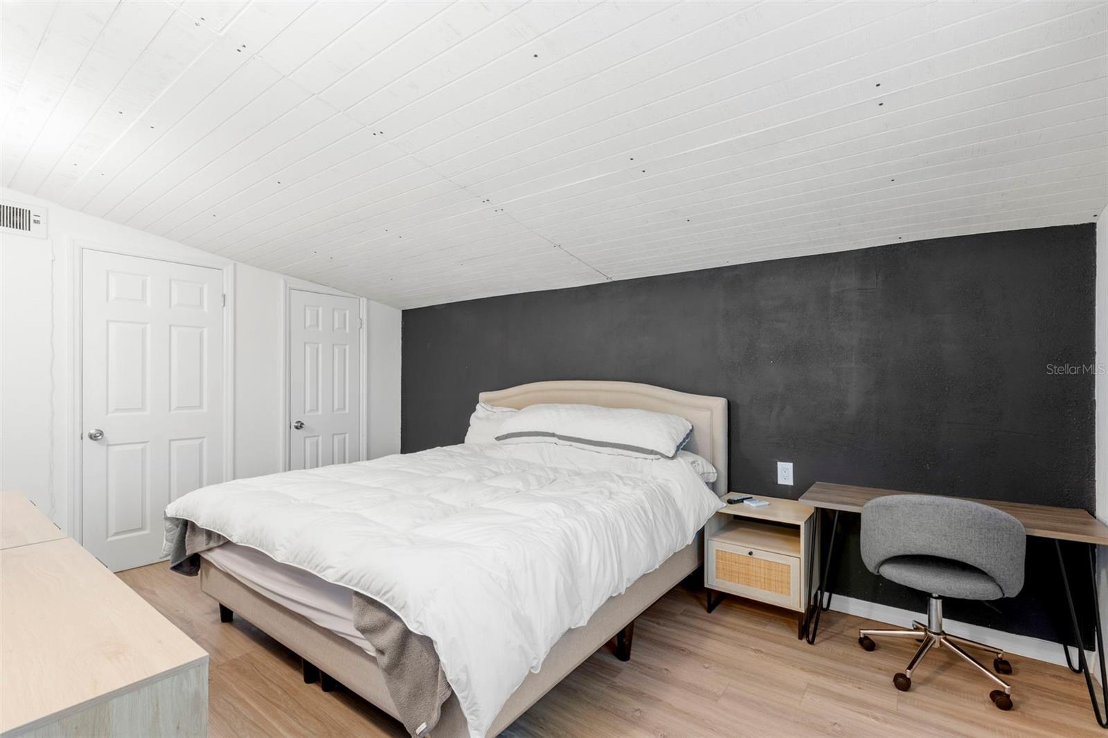 Spacious primary bedroom with room for a king-size bed and additional furnishings.