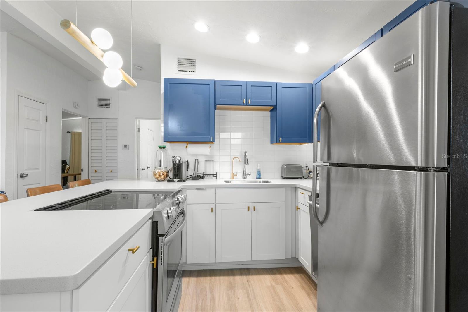 Updated kitchen features stainless steel appliances, recessed lighting, and modern finishes.