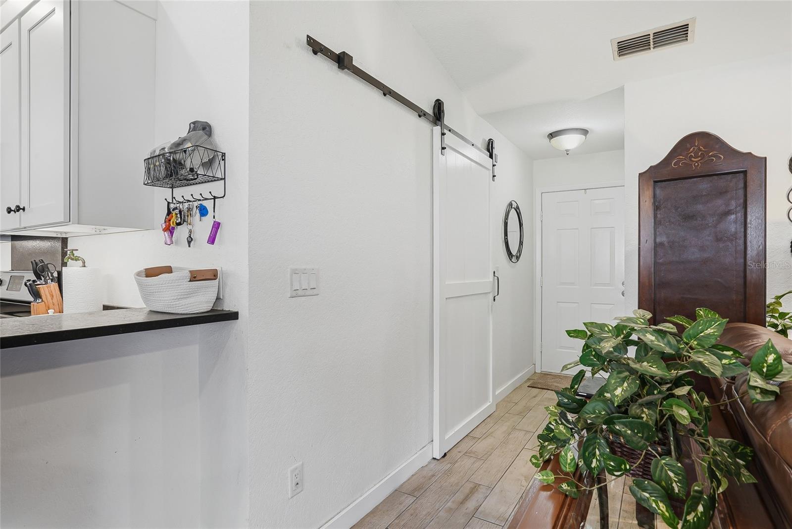 Opposite of the primary bedroom is a secondary bedroom suite behind the barn door.