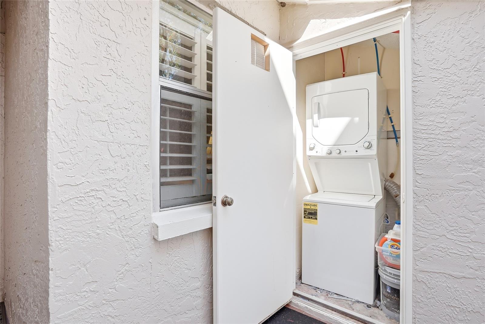 Your own personal, stackable washer and dryer off the courtyard.