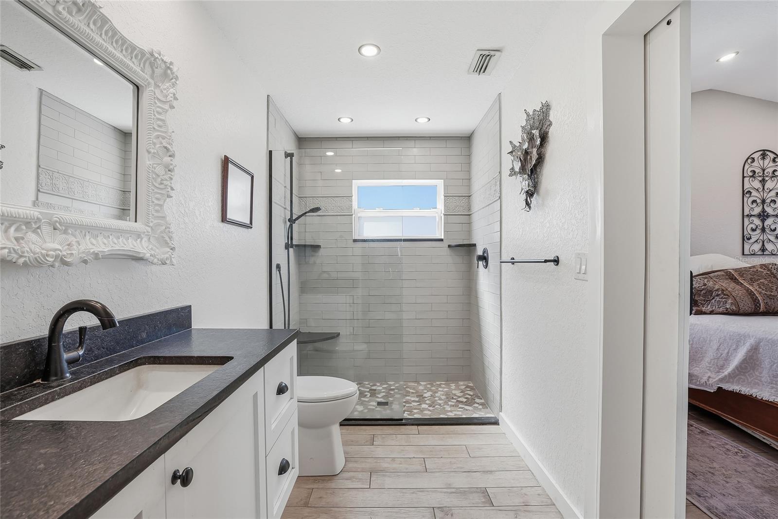 Spacious ensuite primary bathroom with an artisan step in shower.