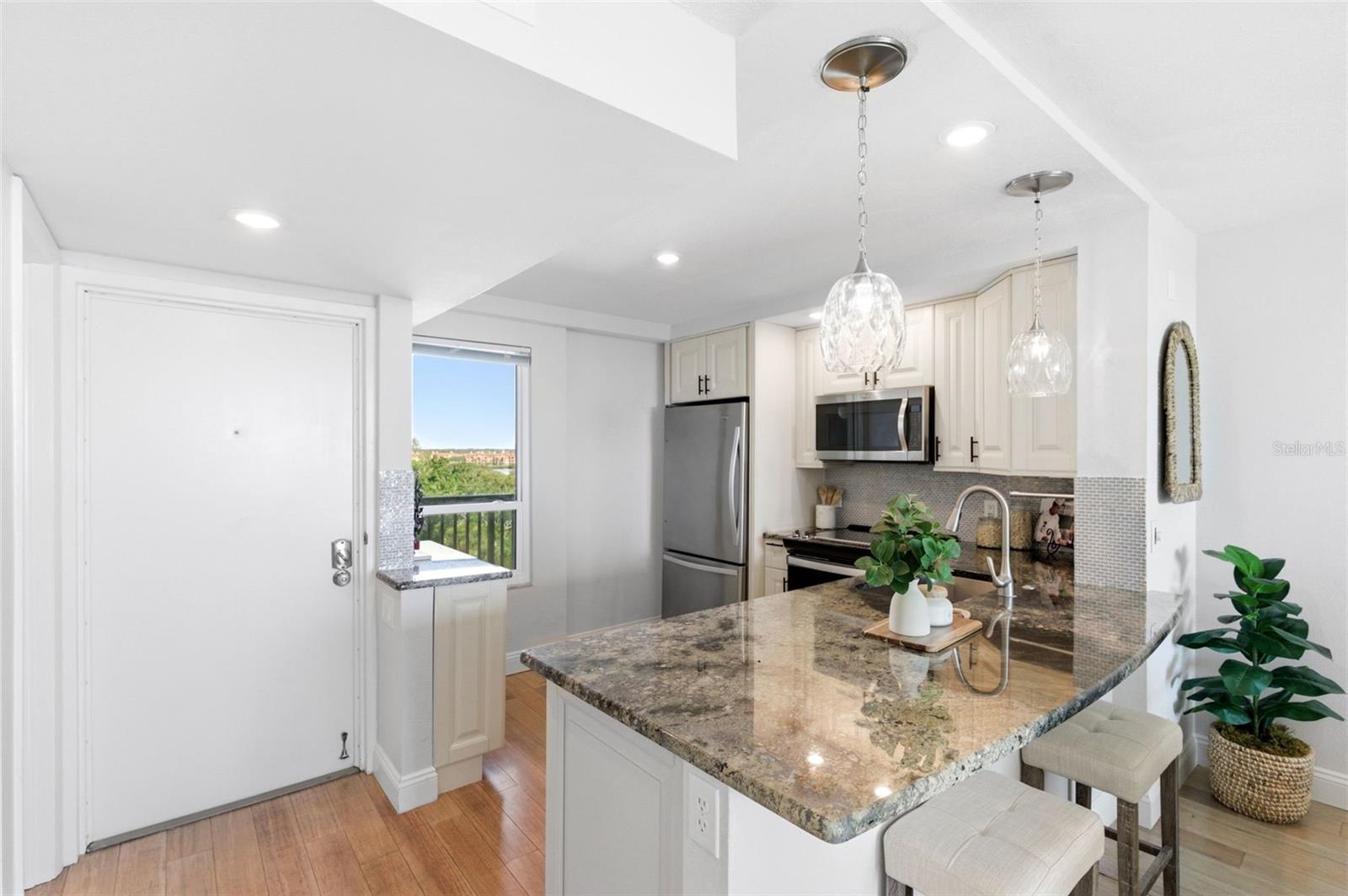 Front door opens to the kitchen on your left and the dining and living room straight ahead.