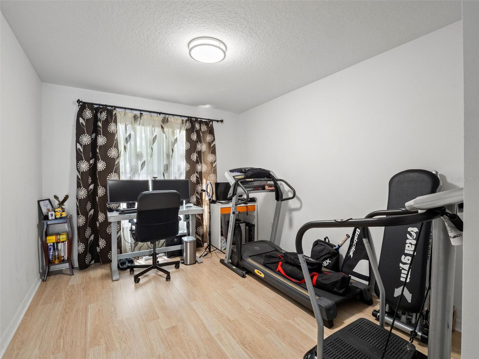 Versatile room ideal for a home office, gym, or hobby space, complete with natural light and functional layout.