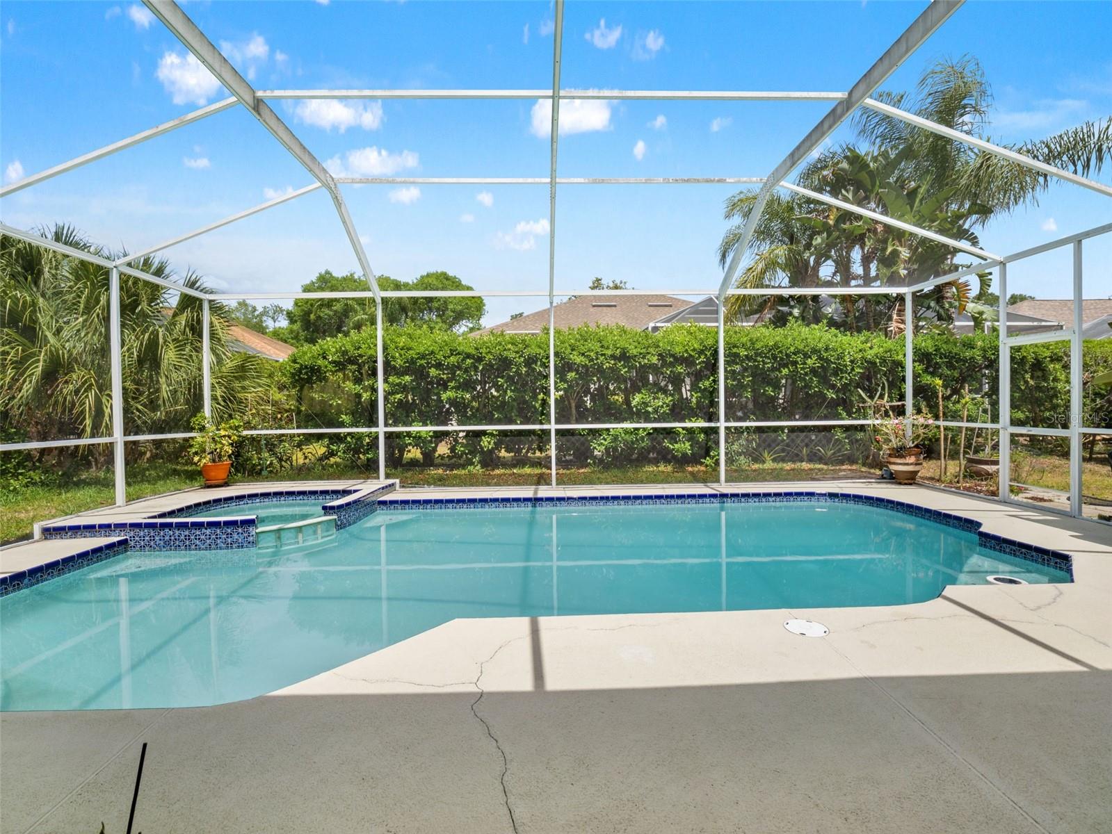 Private screened pool with tranquil water views and surrounding deck space, perfect for enjoying Florida’s year-round sunshine.