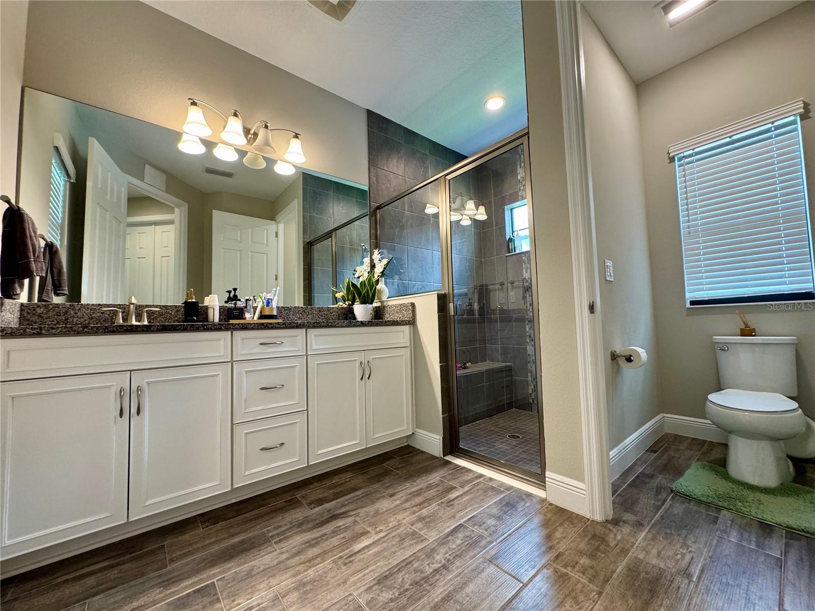 Full Bathroom with walk in shower and bench