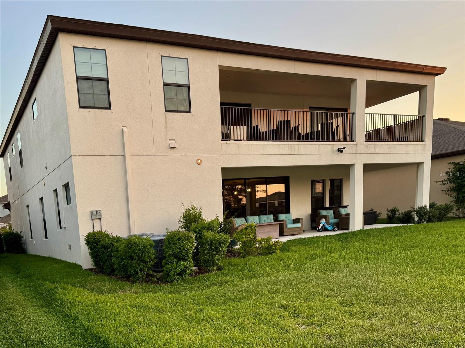 Cozy backyard with covered patio and balcony