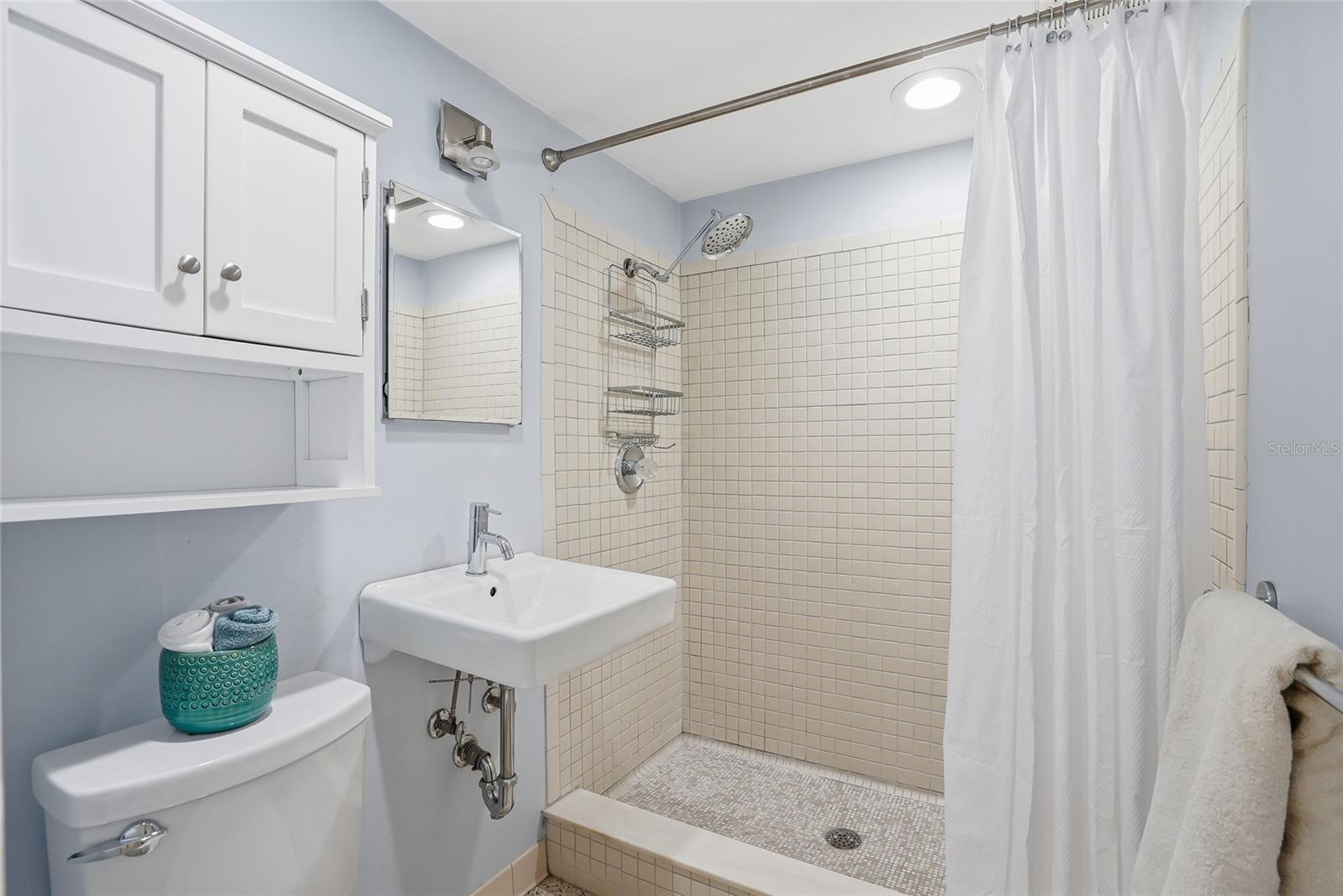 Full bathroom with step in shower.