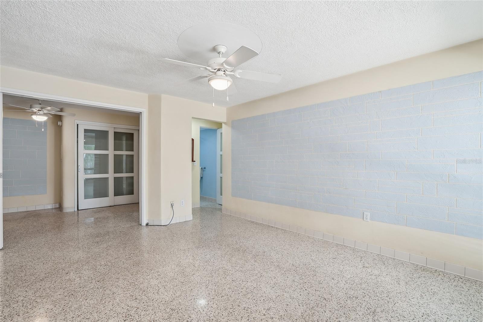 Large living room with gorgeous Terrazzo floors.