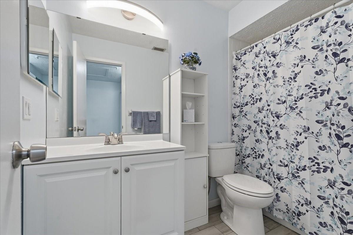 Guest Bathroom with Tub/Shower Combination and Tiled Floor