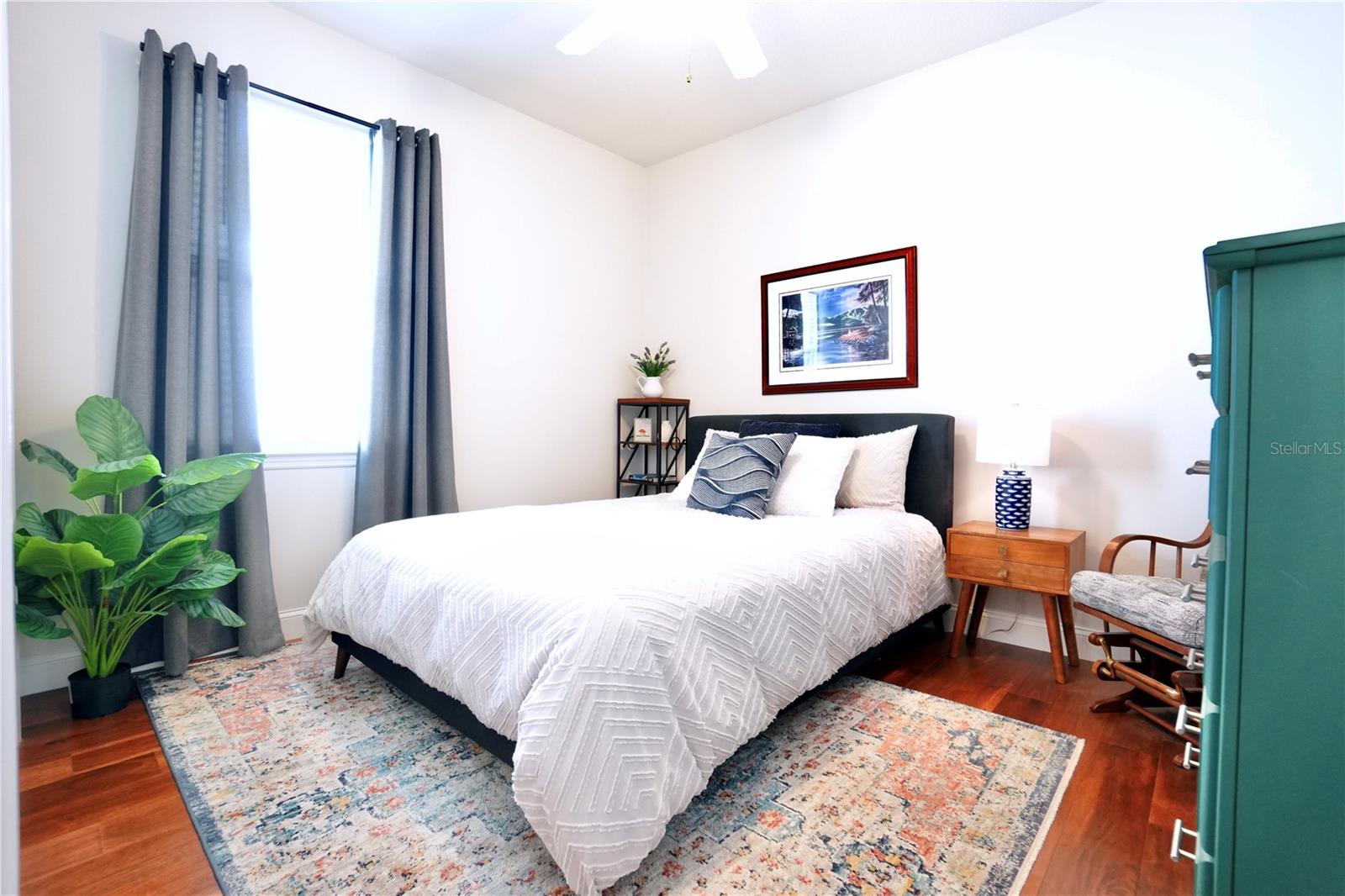 Bedroom 3 with wood floors and ceiling fan.