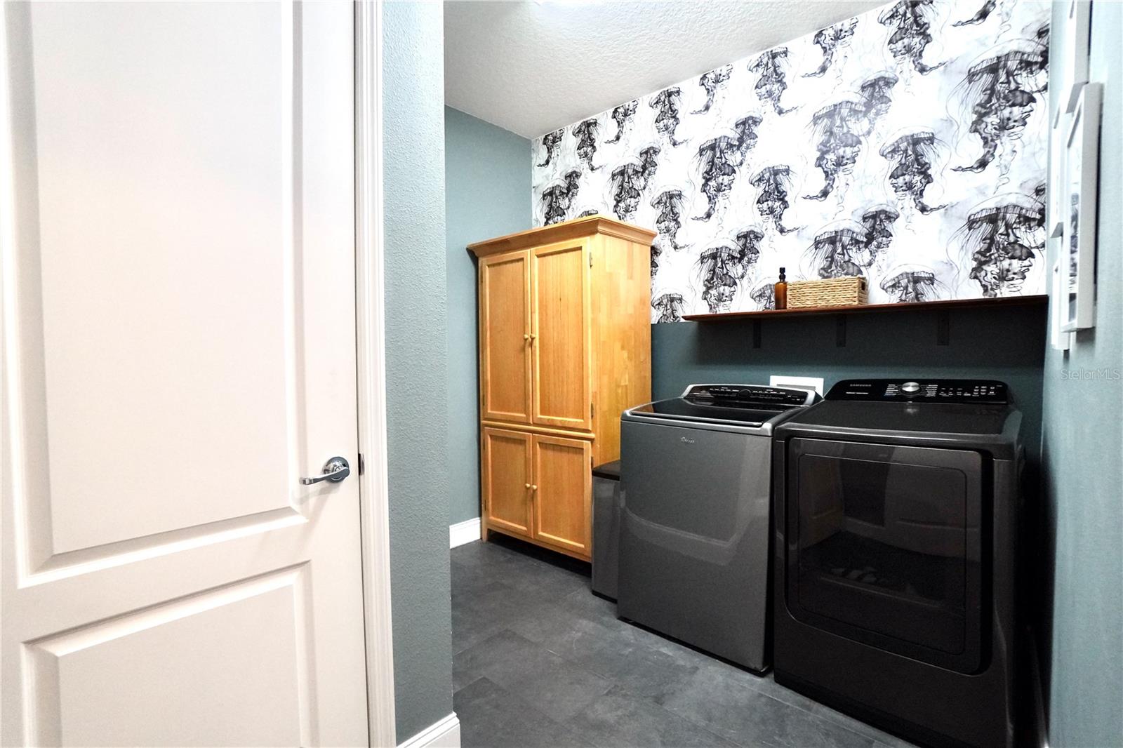 Laundry room with tile floor and closet for AC air handler.
