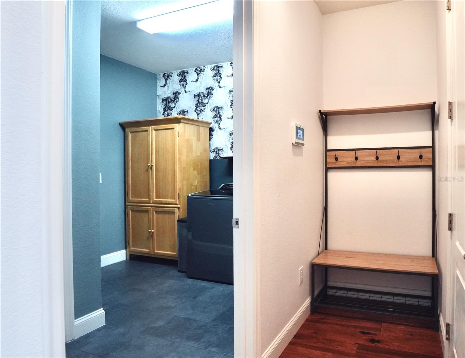 Laundry room and drop space located next to the door entering into the garage.