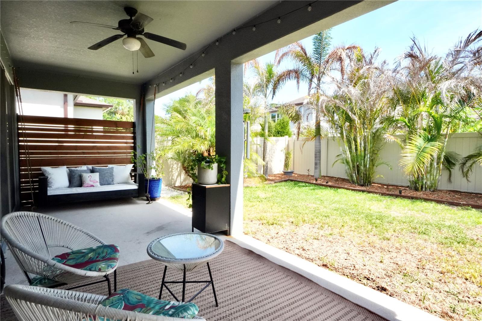 Covered lanai has a porch swing bed.
