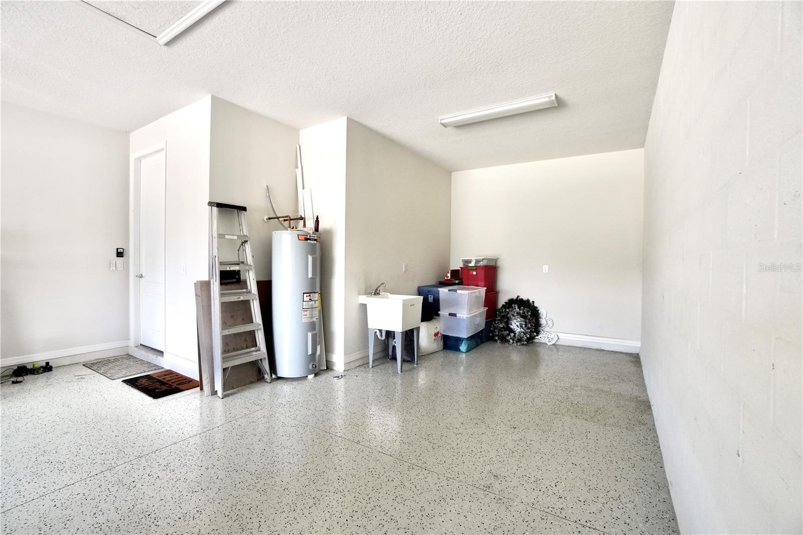 Oversized 2 car garage with epoxy floors, newer water heater and utility sink.