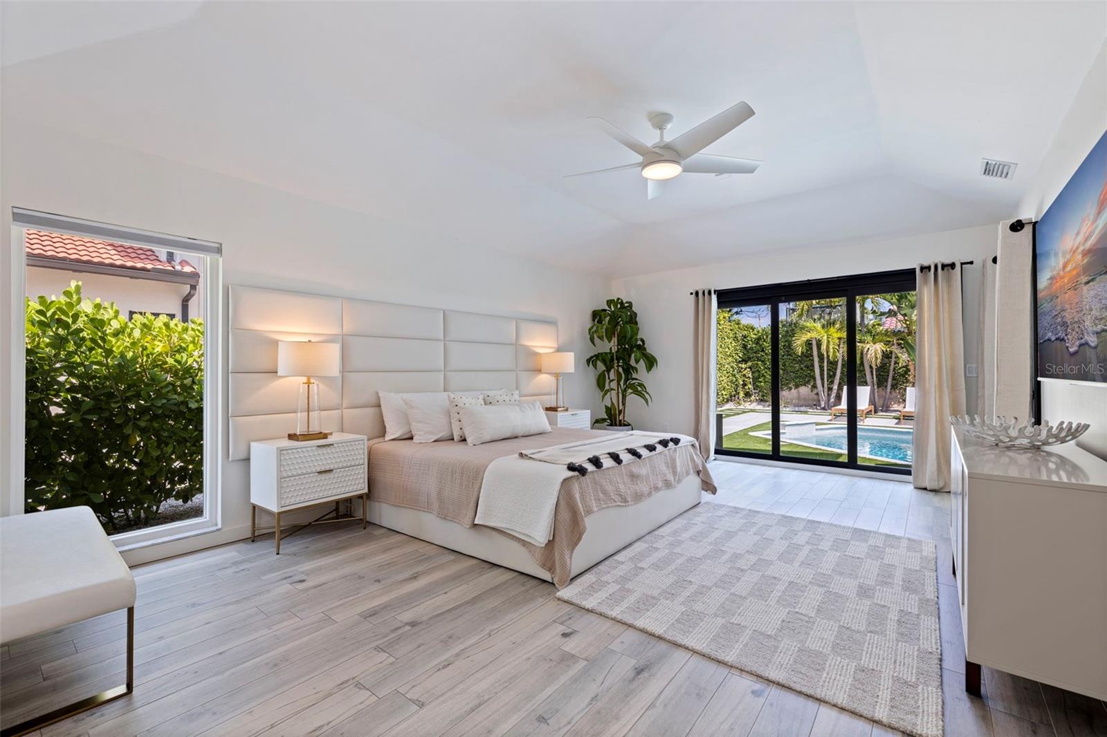 Primary bedroom overlooking pool