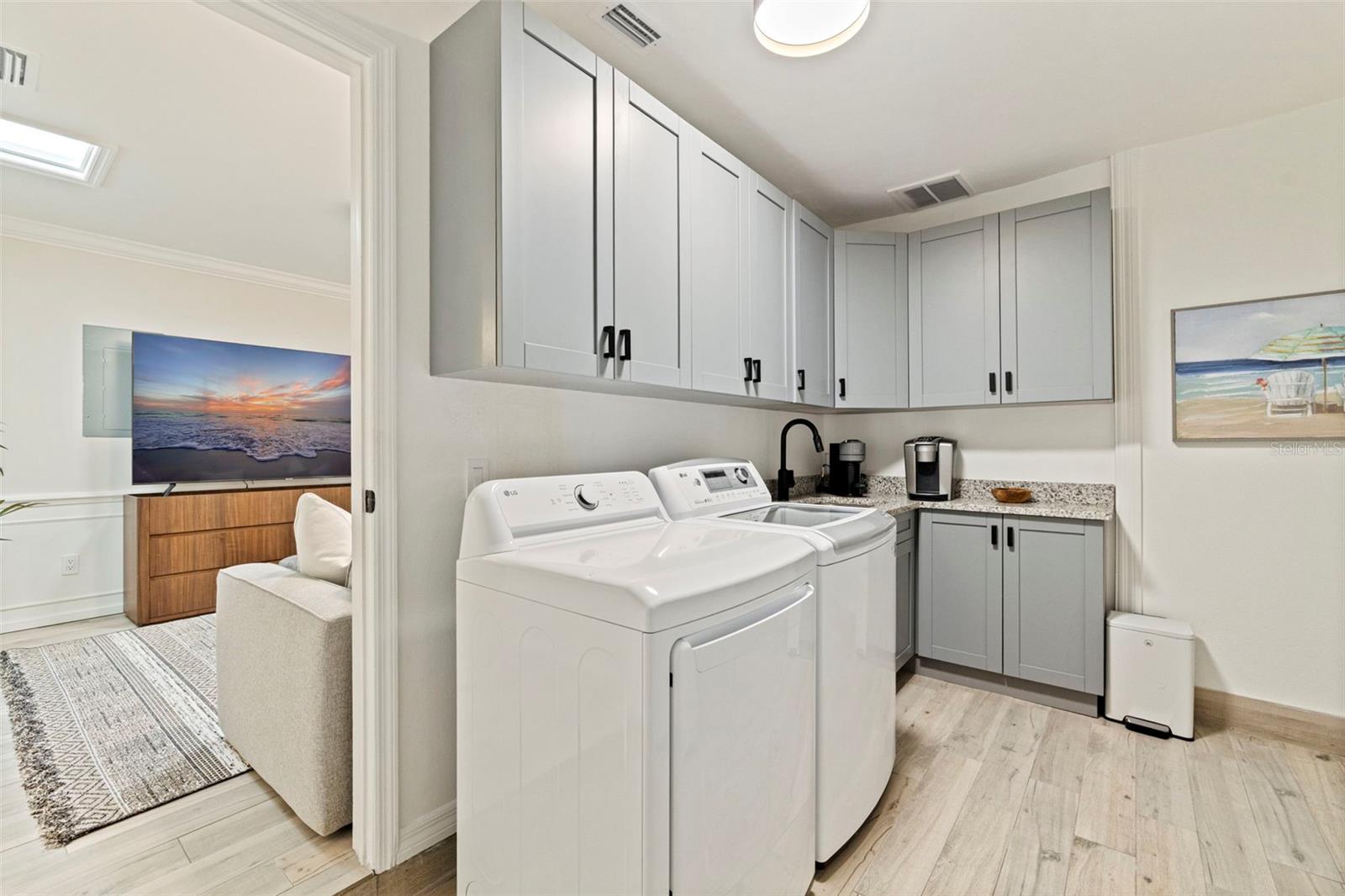 Laundry room with sink and refrigerator