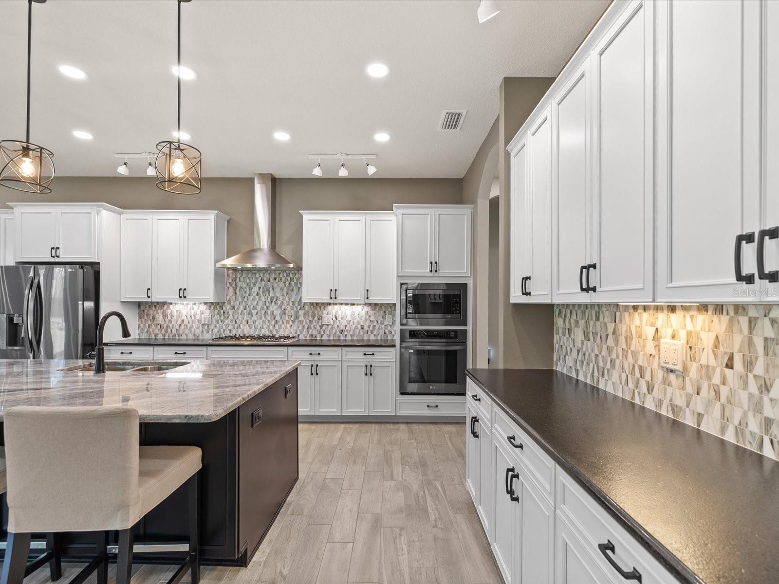 Elegant leather-finish granite countertops complemented by a stunning granite island