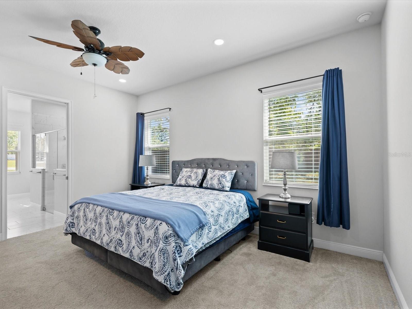 The primary suite offers a generous en-suite bath and an adjacent flex room—perfect for a zen retreat, home office, or additional bedroom