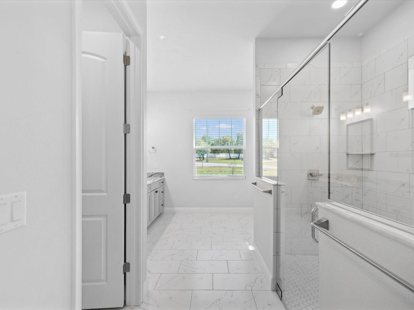 Relax and unwind in the spa-like primary bathroom at 11981 Robina Road, Weeki Wachee, FL.