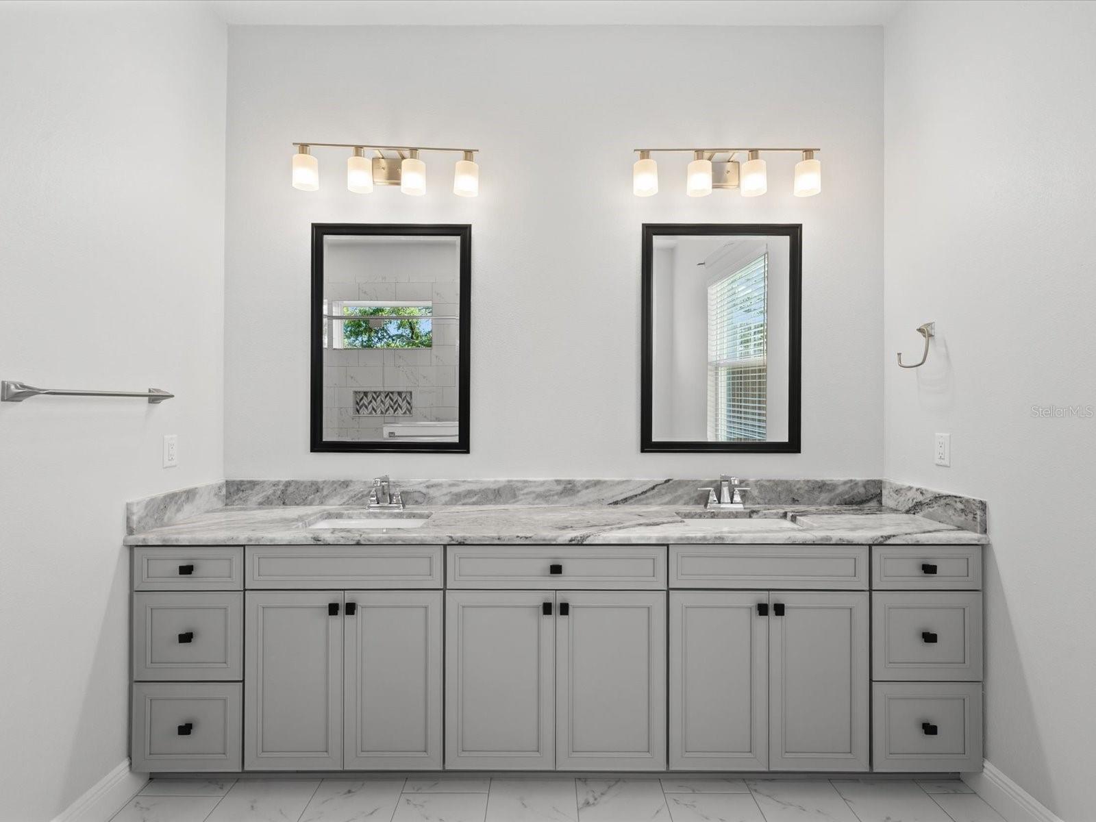 A double vanity with granite countertops, offering timeless elegance