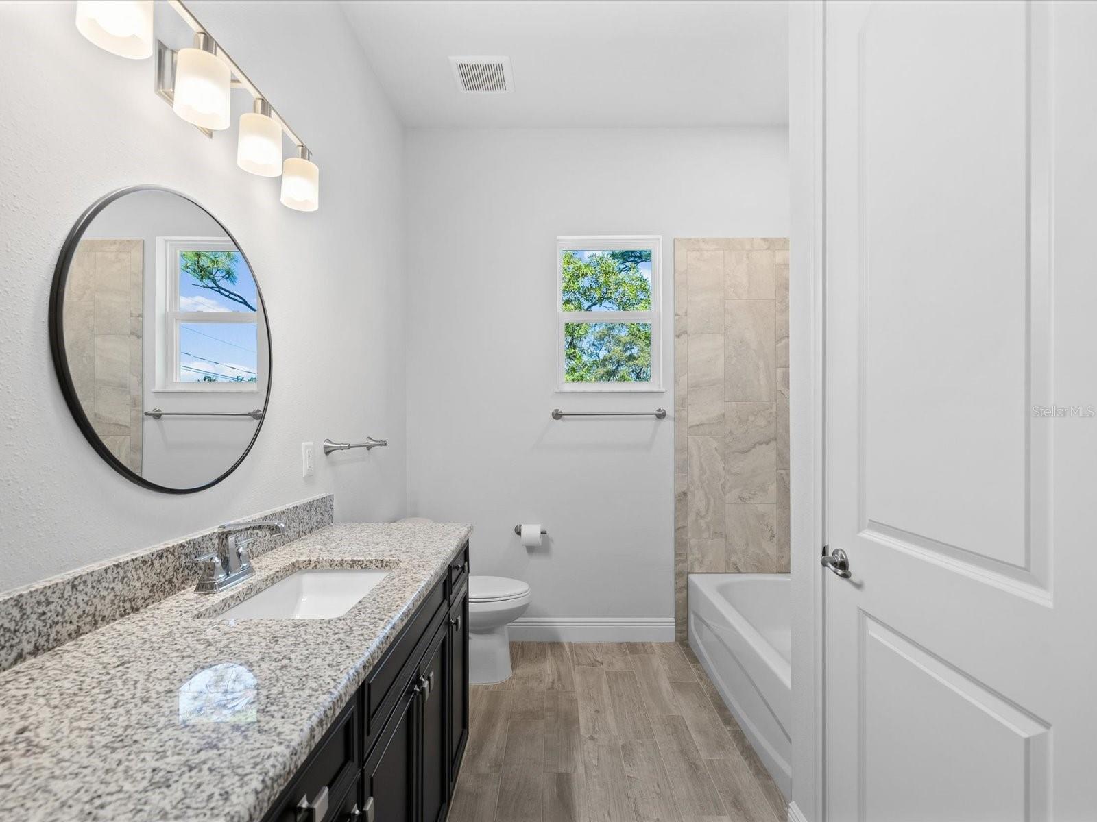 Bathroom 2 offers a stunning shower along with a beautifully appointed tub
