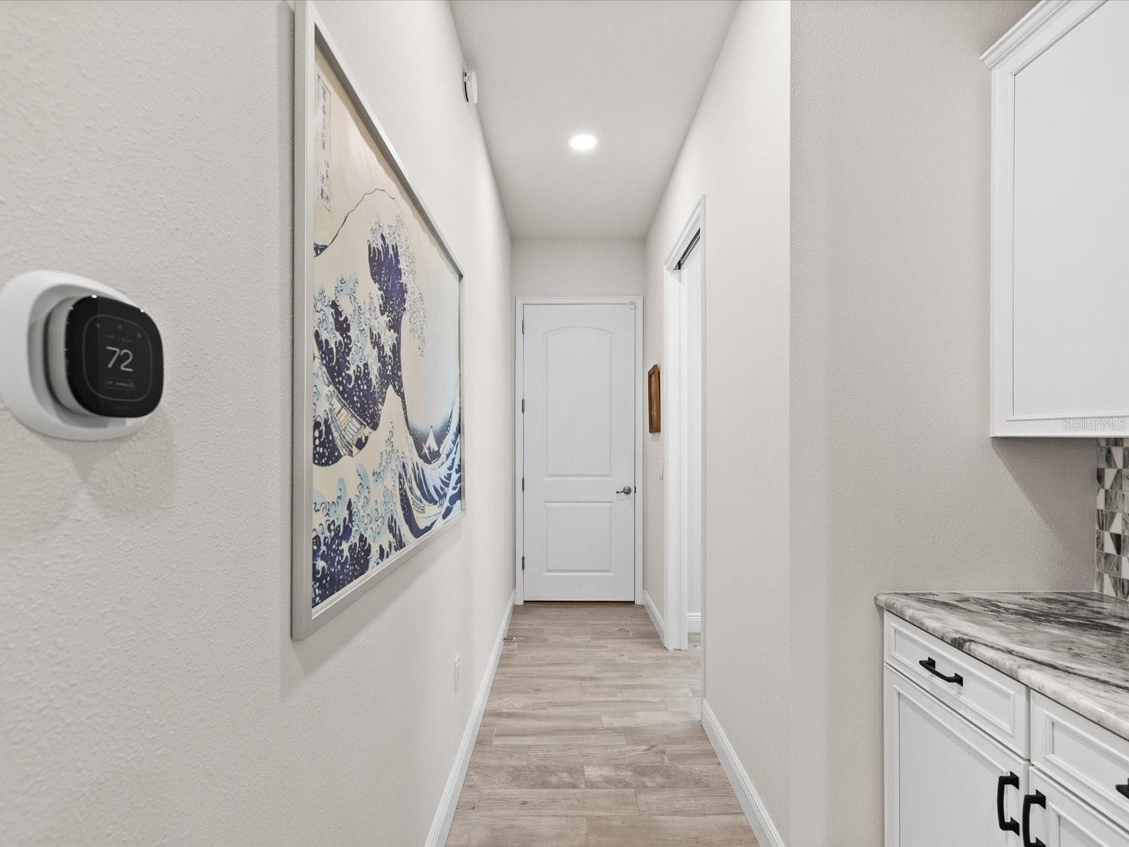 “A thoughtfully designed drop-zone desk and hallway connecting seamlessly from the garage