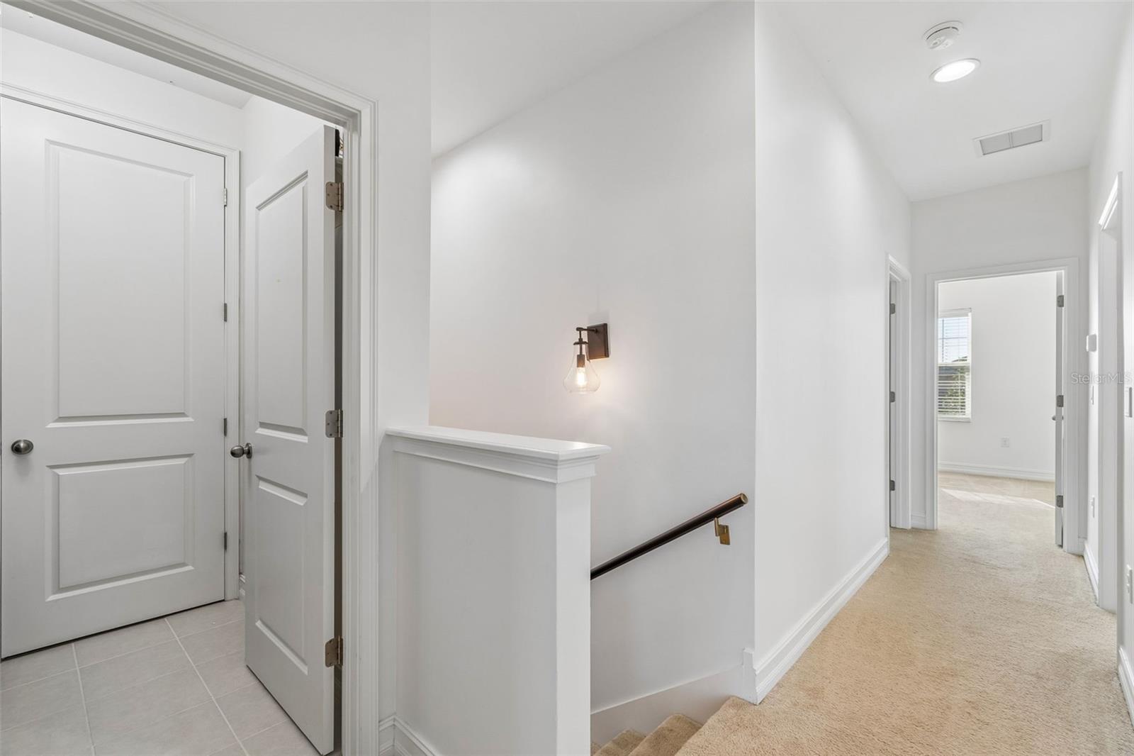 View from Primary bedroom down hallway & laundry room