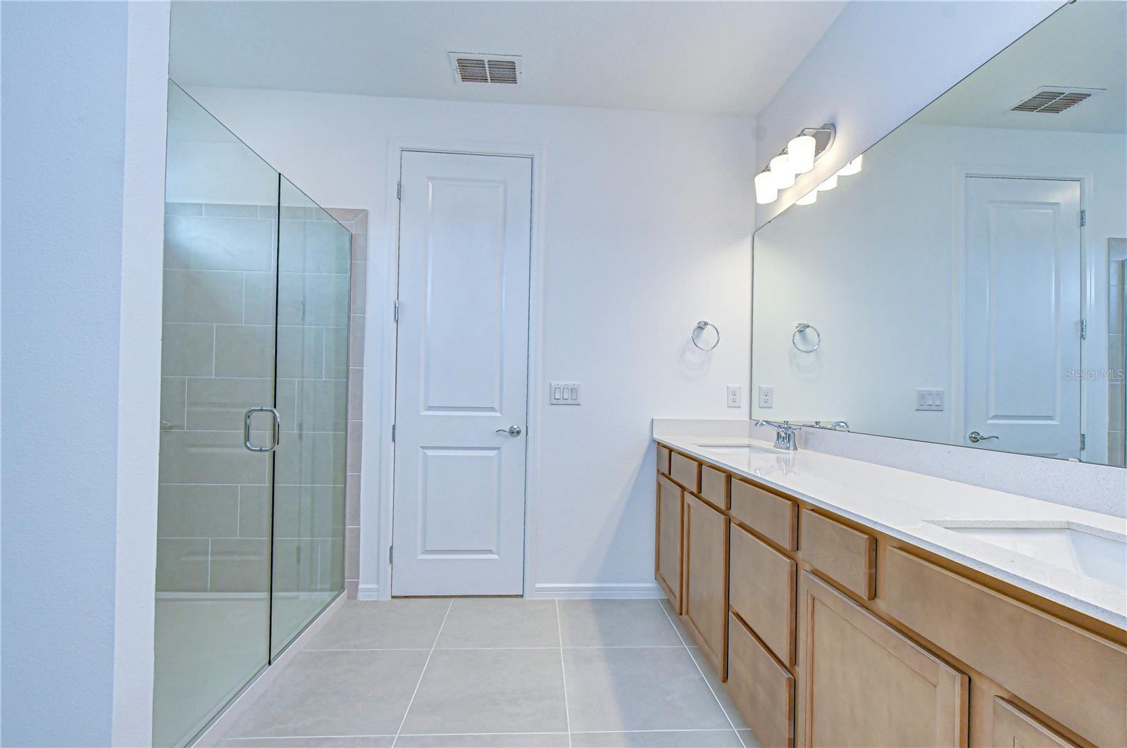 Double sinks with quill cabinetry and quartz countertops