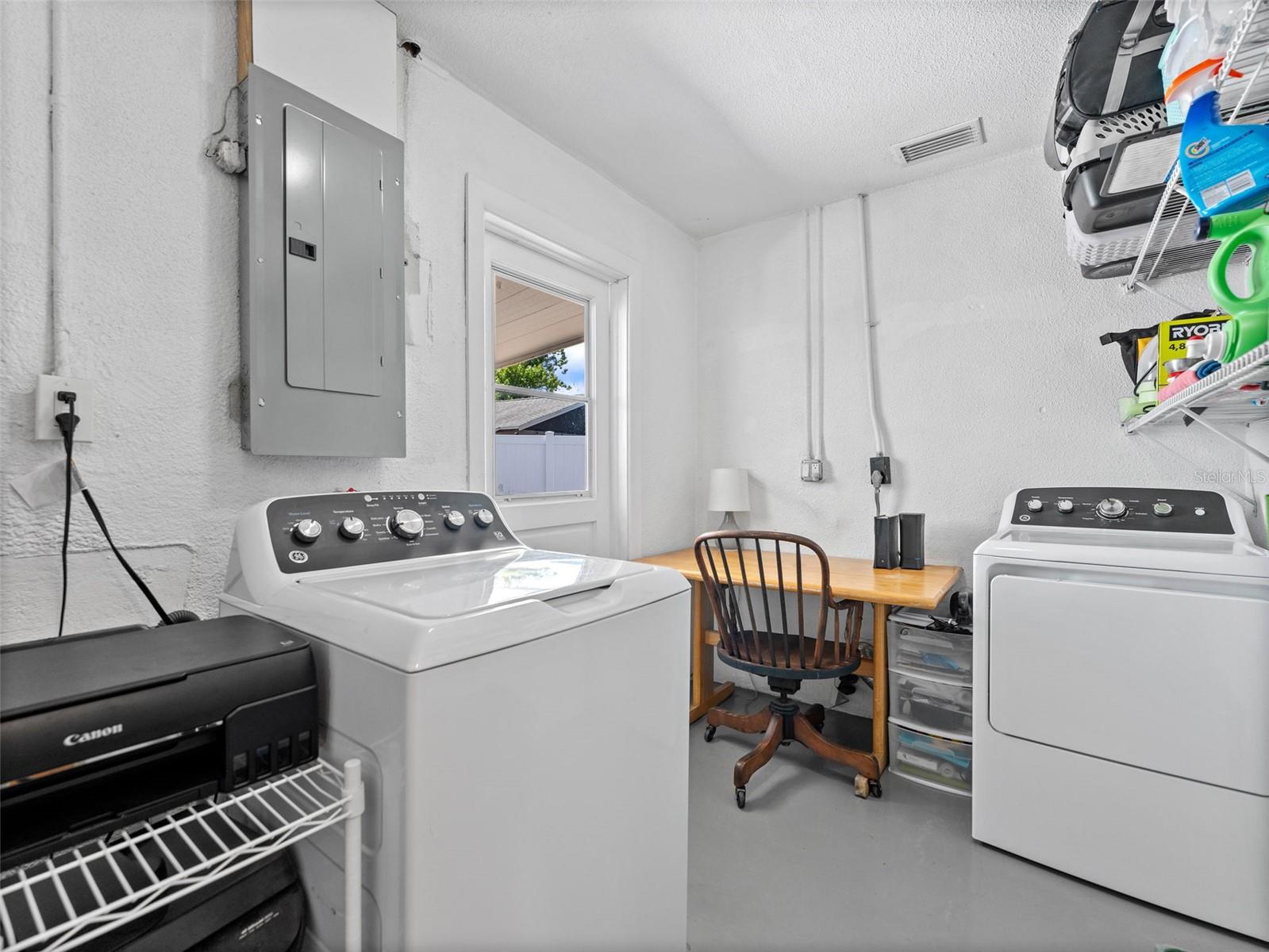 Large utility room with additional space for a desk and storage