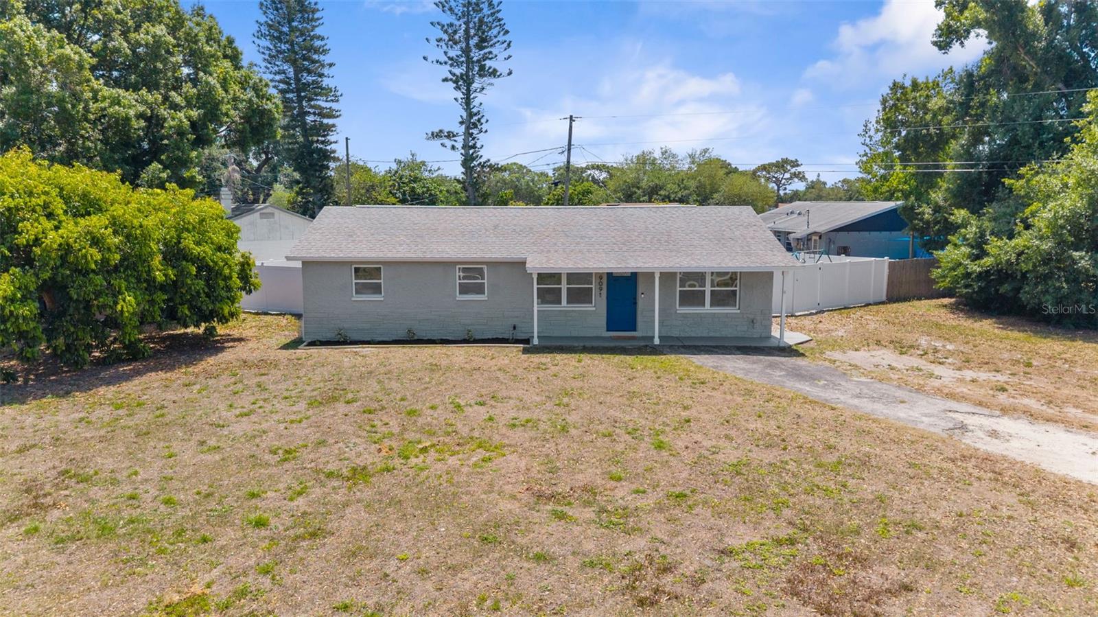 Drone shot of the front exterior of the home and property