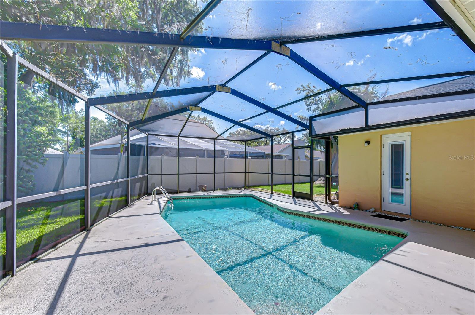 Generously sized covered seating area within screened lanai