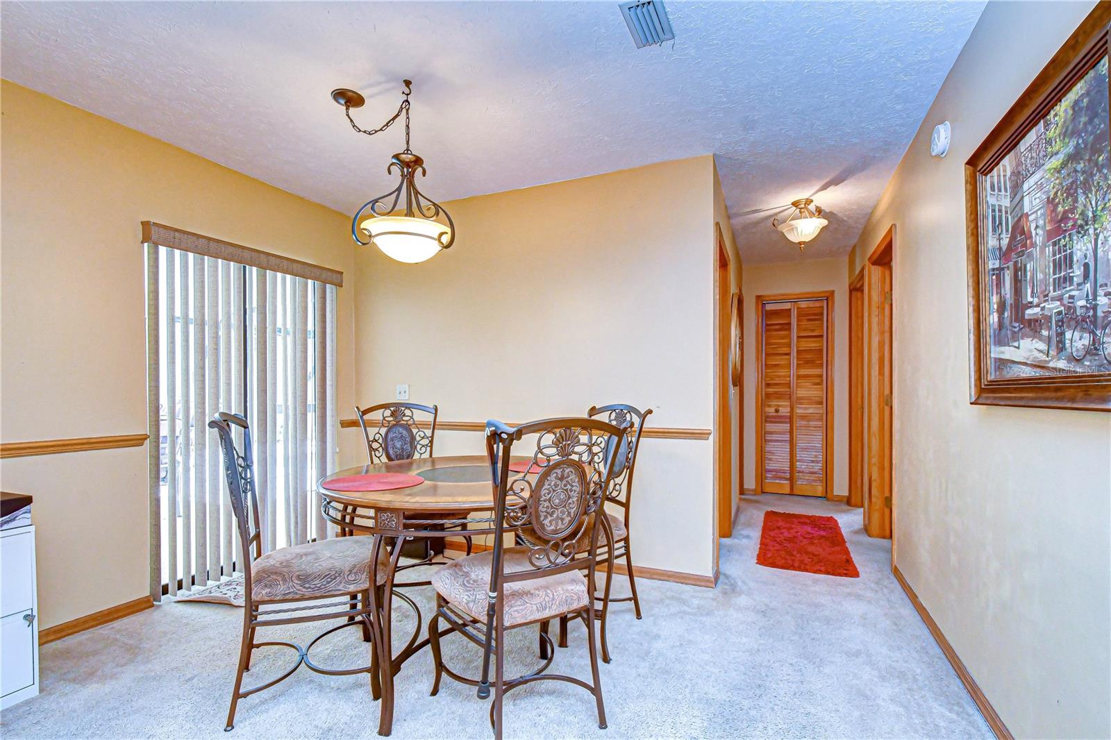 Sunlit dining area overlooking the pool