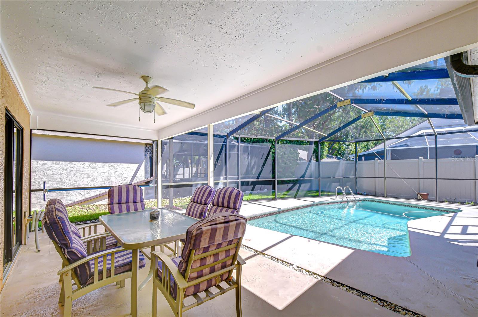 Generously sized covered seating area within screened lanai