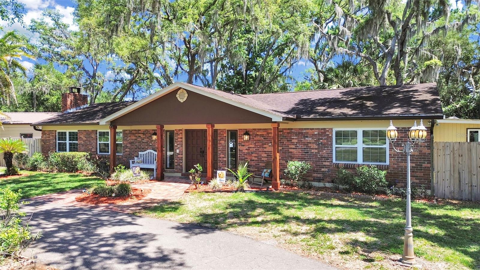 Welcome to 18835 Tracer Drive, a classic brick ranch home, nestled under a canopy of majestic mature trees, with charming curb appeal & a welcoming covered front porch.