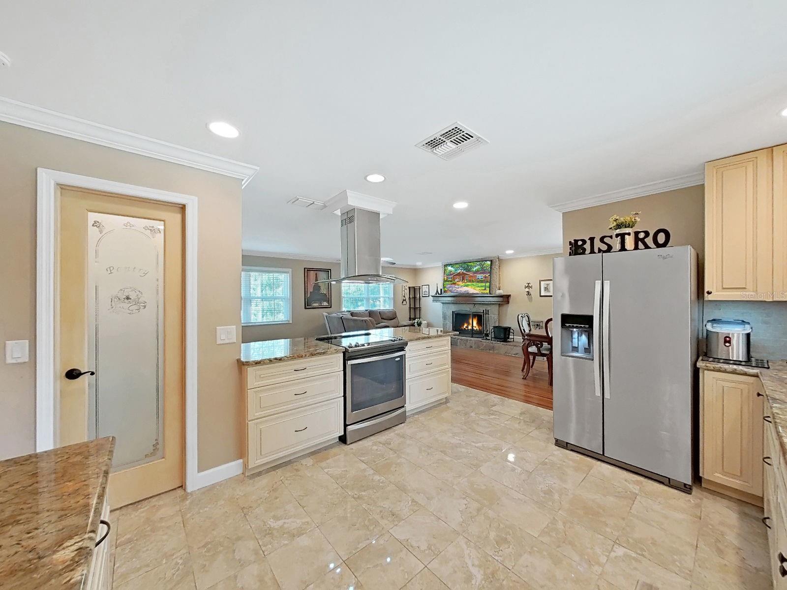 Open kitchen with a seamless view into the living room & fireplace. A functional & connected layout perfect for everyday living! Walk-in Closet Pantry through the decorative glass door.