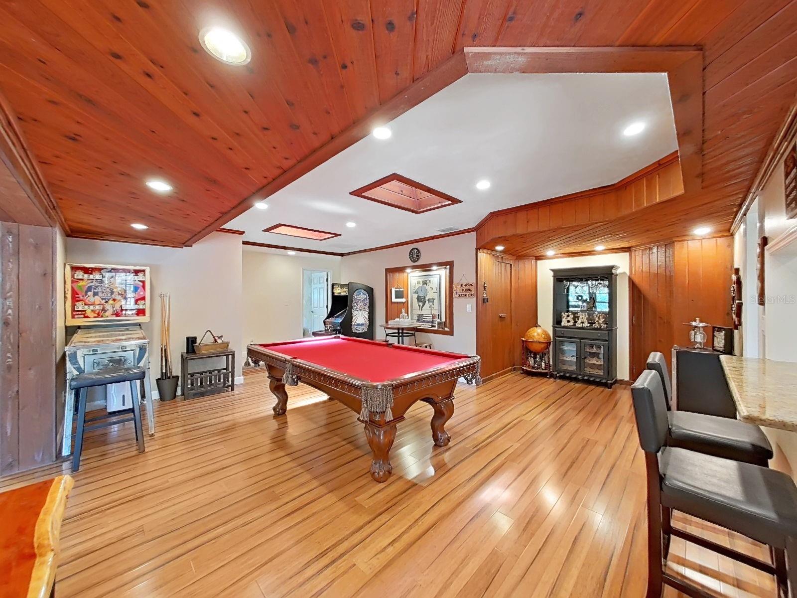 While currently being used as a Game Room, this bonus room offers so much flexibility in use! Near the "BAR" sign in the back, you'll find two secret doors, concealing the spacious laundry room (on the left) & an electrical storage room (on the right).