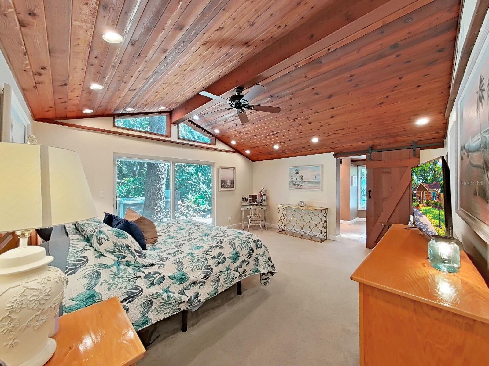 Stunning Primary Suite with vaulted ceiling, recessed lighting, private En Suite bathroom, walk in closet, & serene backyard views and access- a true retreat!