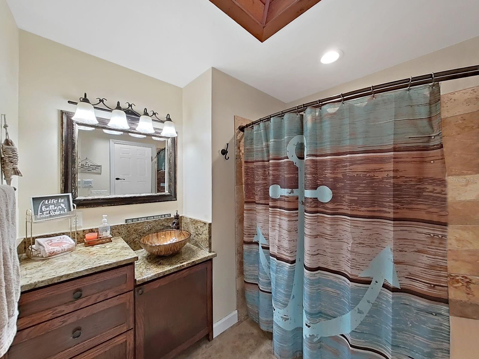 Bathroom 2- Granite vanity, contemporary finishes, skylight, and tub/shower combo.