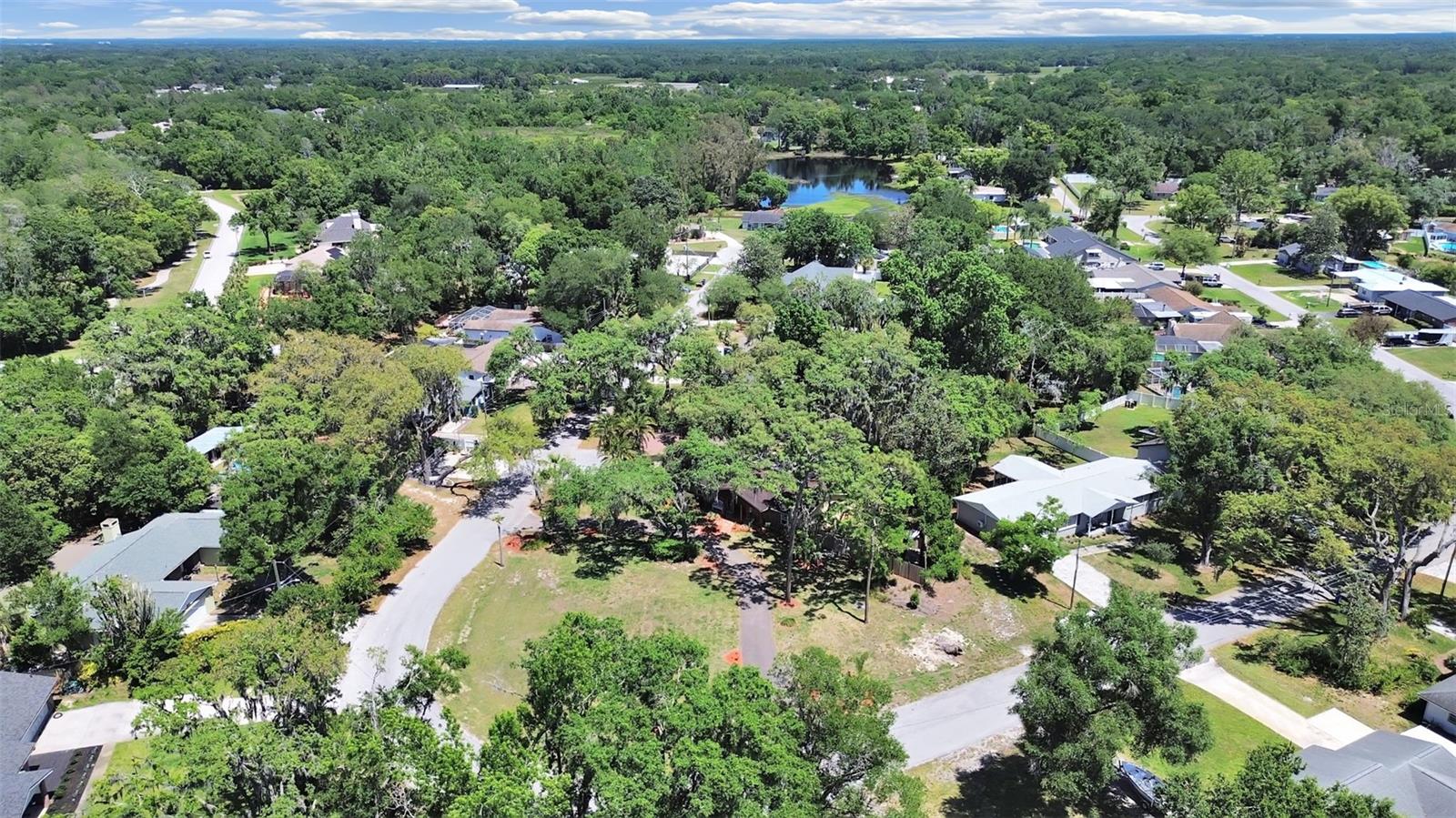 Notice the large, oversized corner lot, spanning the entire curve of the street. Nestled in an established neighborhood with mature trees and greenery.
