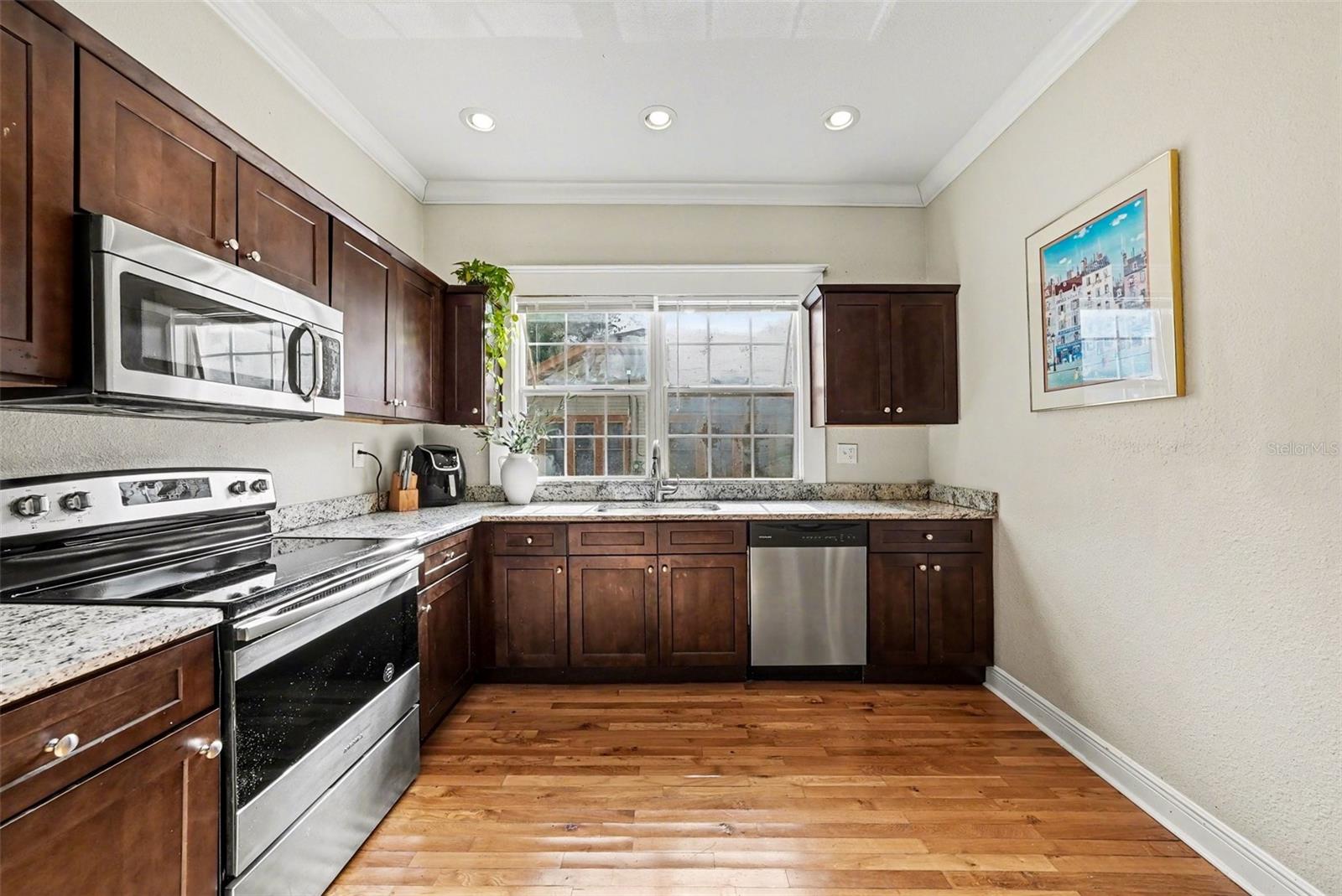 Kitchen with solid wood cabinetry, stainless appliances, and ample counter space.